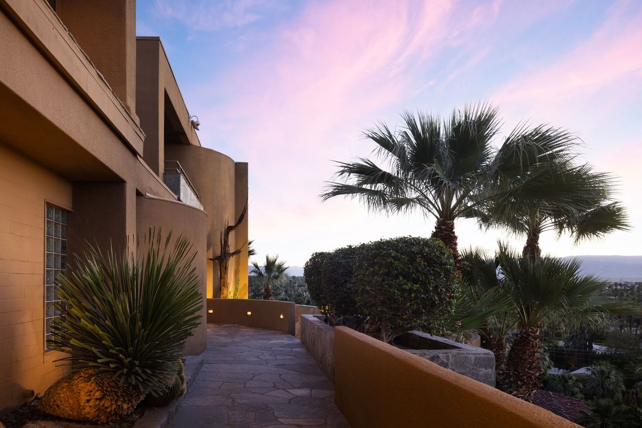 Terrace walkway at sunset with desert plantings and palms